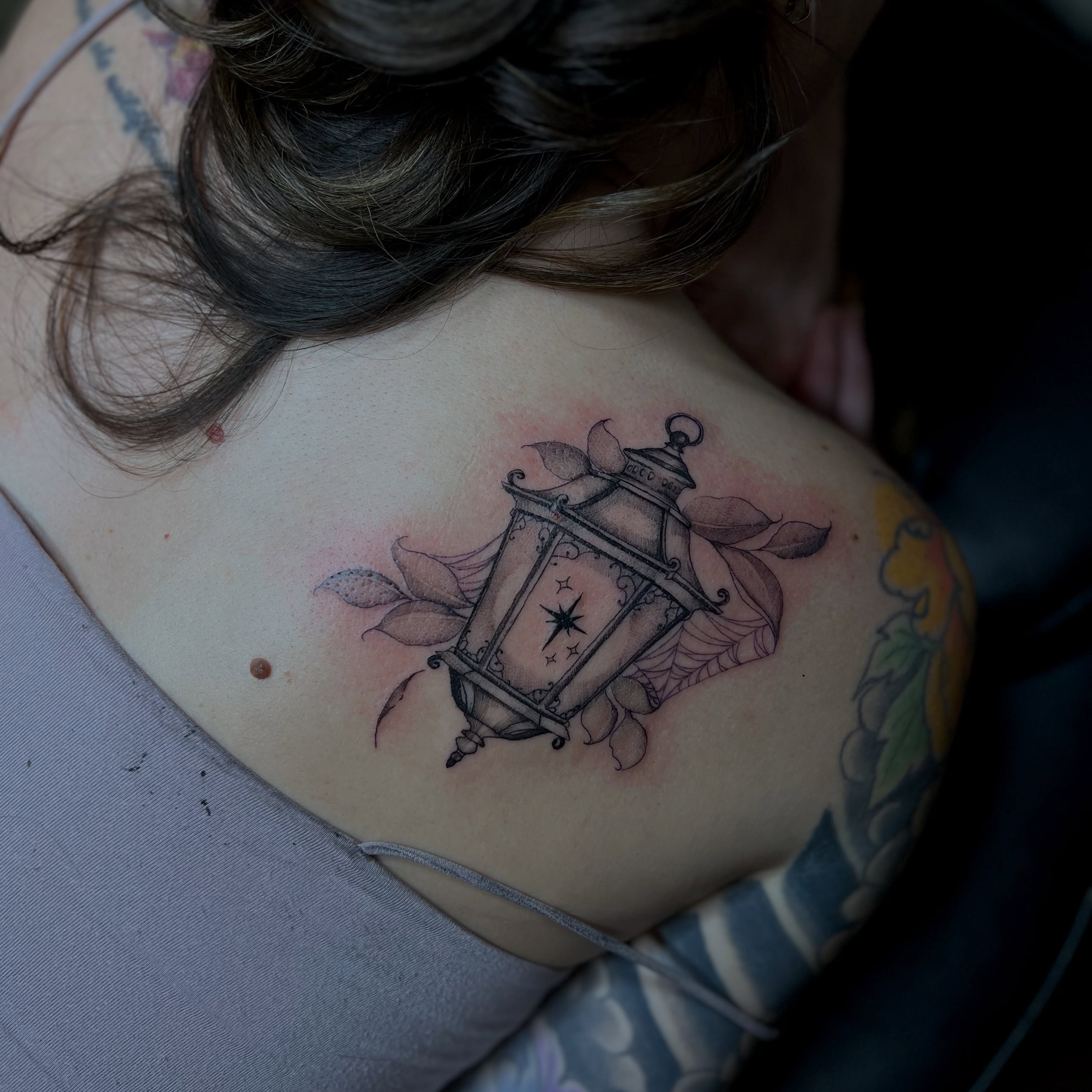 Botanical lantern tattoo by Clancy Murphy